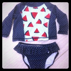 Navy polka dot swimsuit with rash guard.